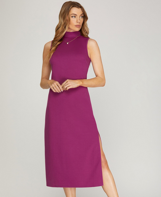 Solid color mock neck sleeveless midi dress with a mid-thigh side slit. Available in berry or rust.