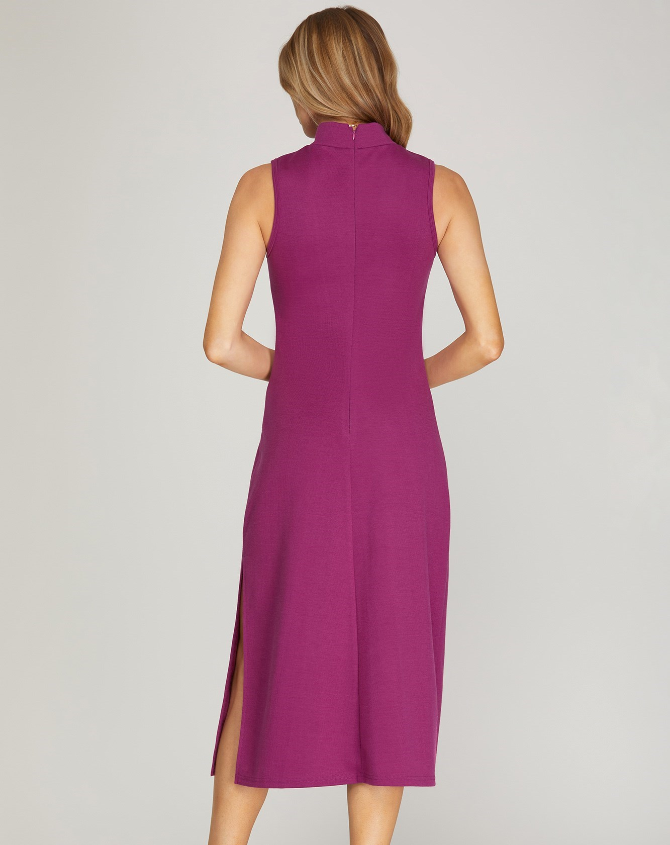 Solid color mock neck sleeveless midi dress with a mid-thigh side slit. Available in berry or rust.