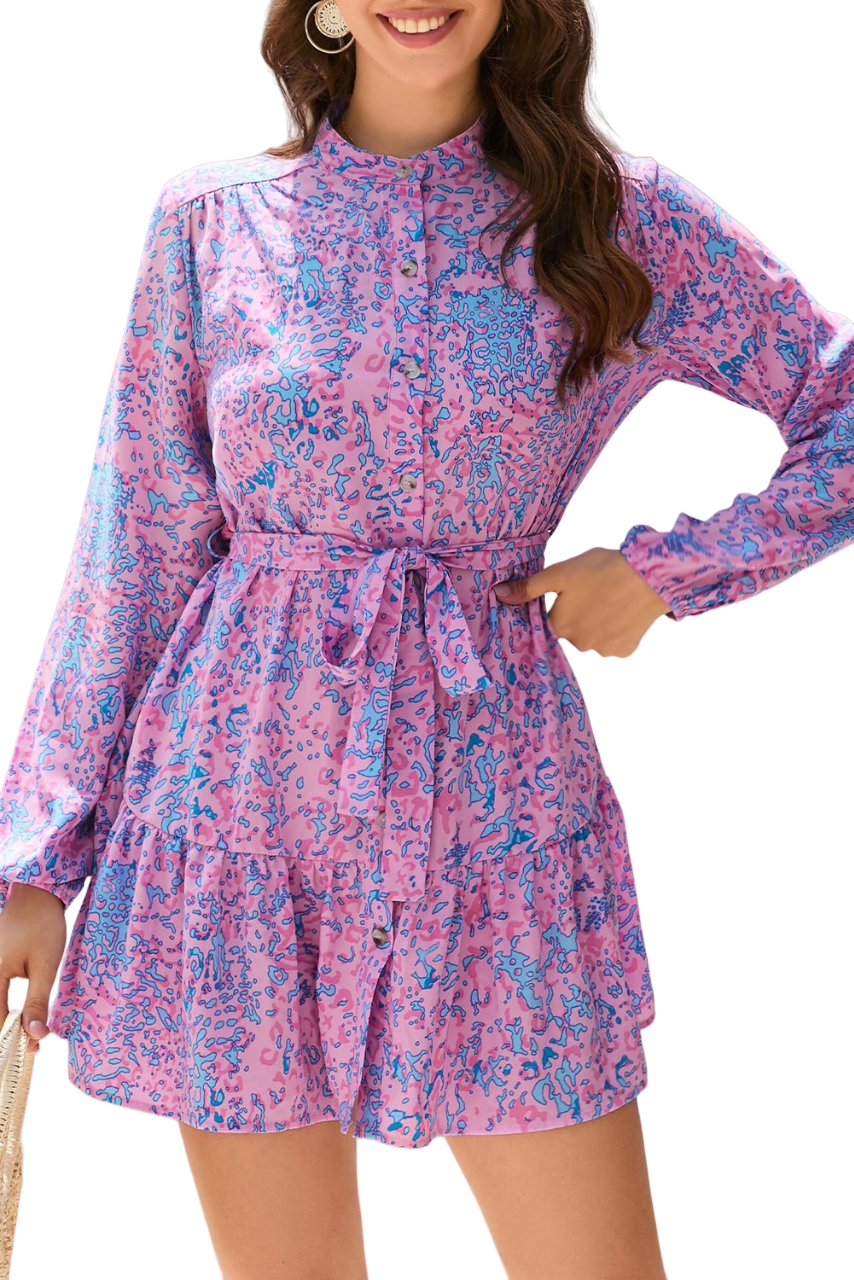 Pretty in pink and blue, such a fun print! This chic shirt dress buttons down the front, has a ruffle trim hem and tie waist. 