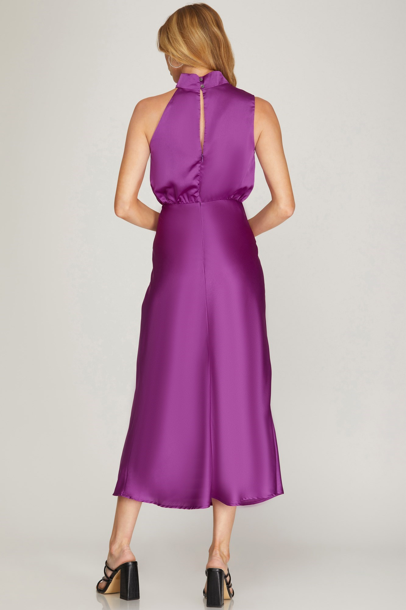 A sleek, sleeveless midi dress crafted with a bold, asymetrical neckline.