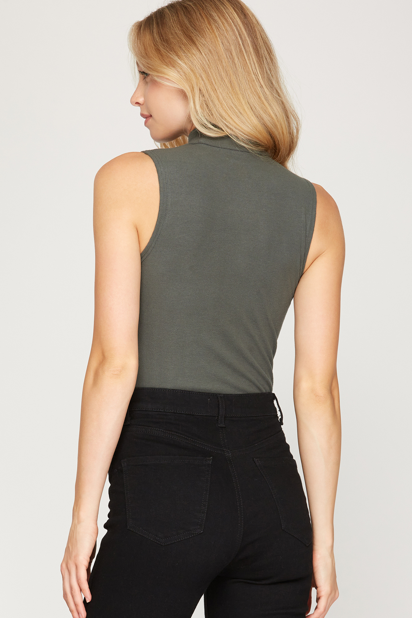 Brushed knit sleeveless mock neck bodysuit. Solid colors - available in slate, black, mocha, and cream. Snap closure.