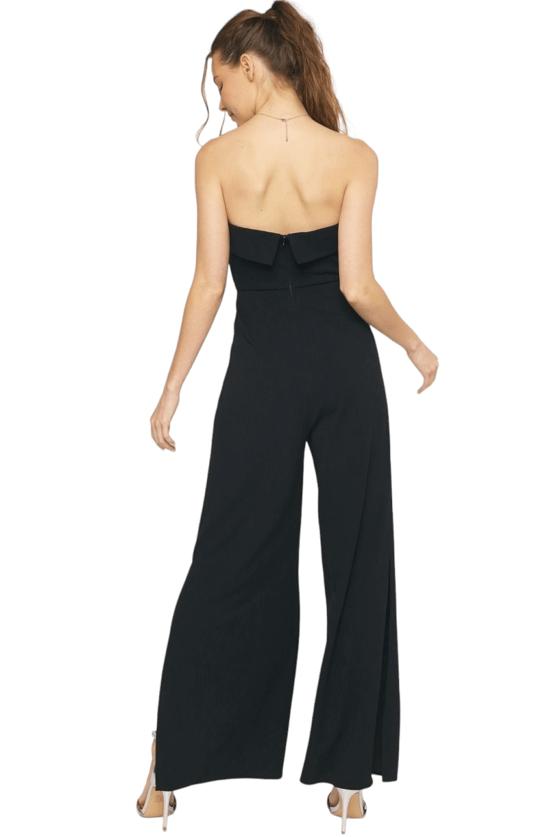 Solid strapless jumpsuit featuring fold over detail at bust. Side slit on pant. Pockets at side. Invisible zipper at back. Unlined. Woven. Non-sheer. 