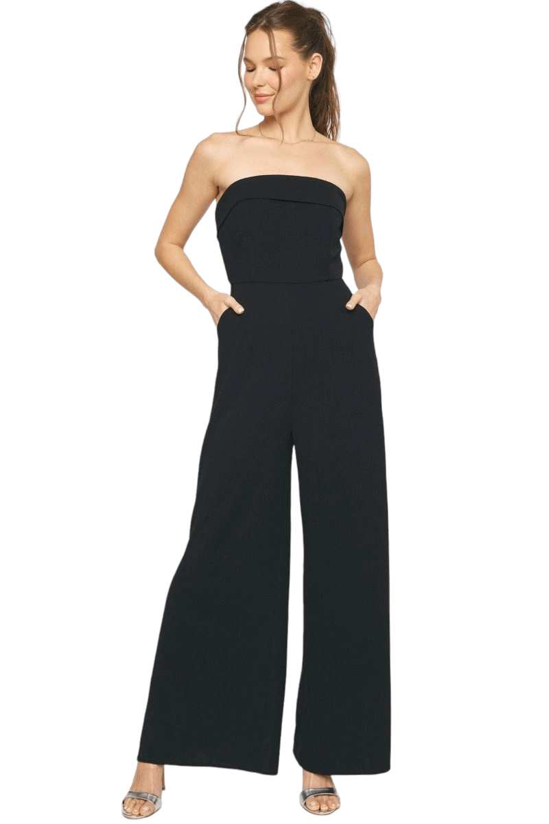 Solid strapless jumpsuit featuring fold over detail at bust. Side slit on pant. Pockets at side. Invisible zipper at back. Unlined. Woven. Non-sheer. 